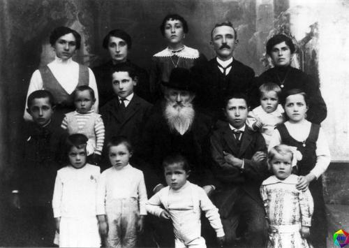 Anziano patriarca circondato dalla sua famiglia (Italia, intorno al 1910).